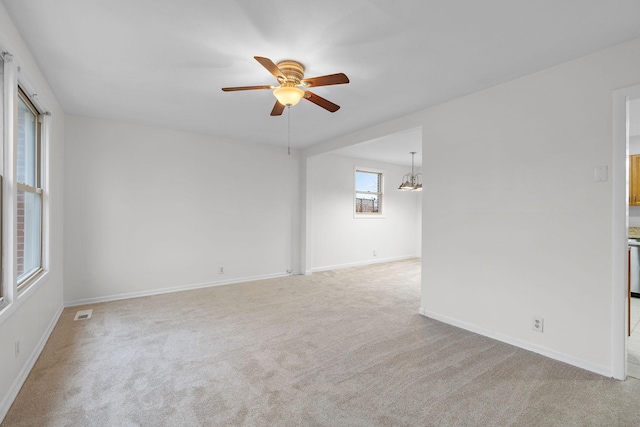 empty room featuring light carpet and ceiling fan