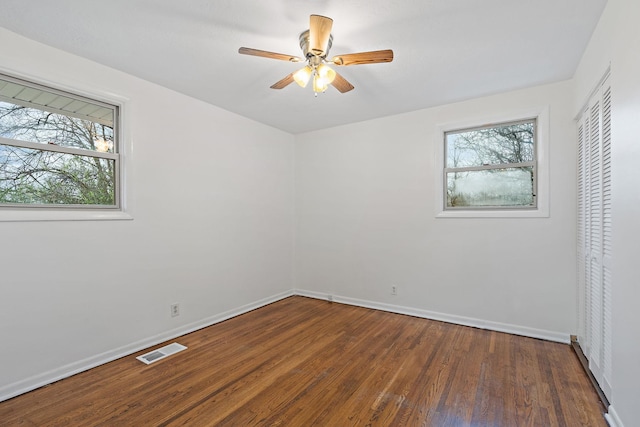 unfurnished bedroom featuring ceiling fan and dark wood-type flooring