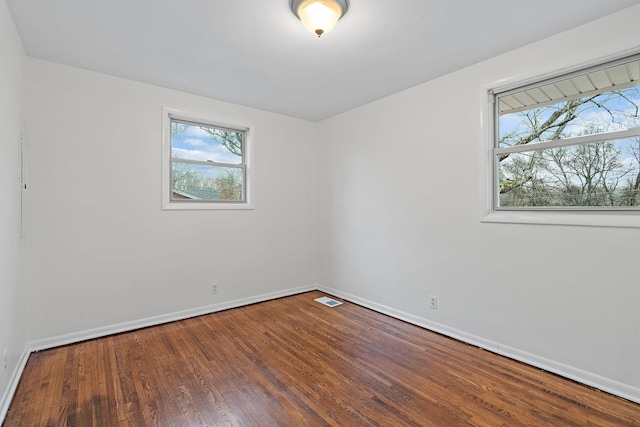 spare room with wood-type flooring