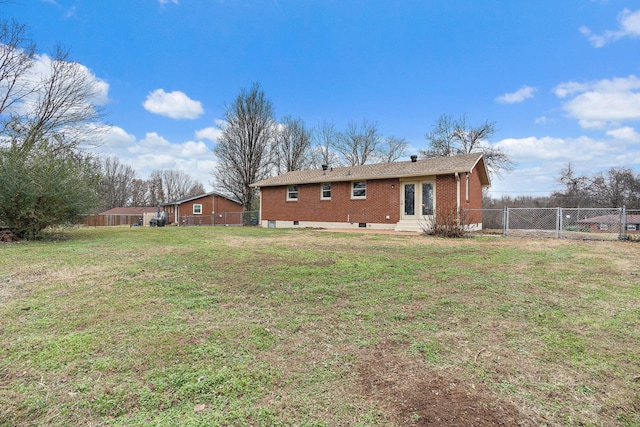 rear view of property featuring a lawn