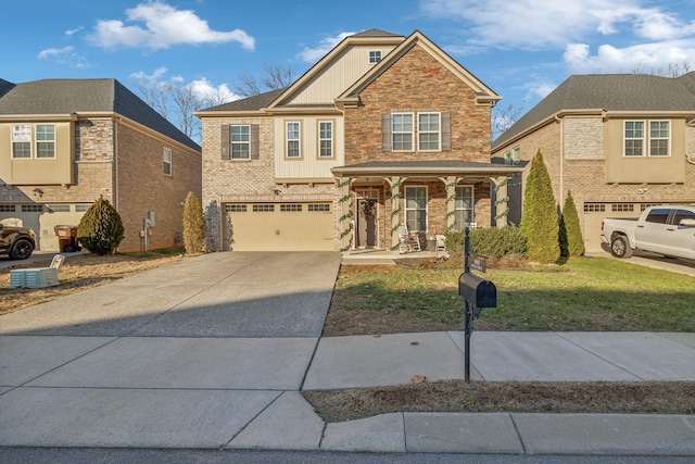 view of front of house with covered porch, a garage, and a front yard