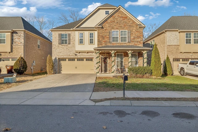 view of front facade featuring covered porch, a front yard, and a garage