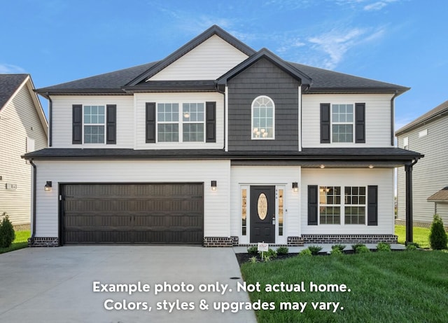 view of front of property with a garage and a front lawn