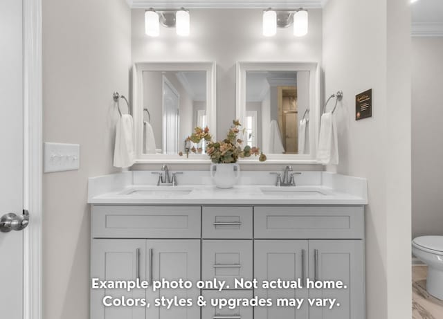 bathroom with vanity, ornamental molding, and toilet