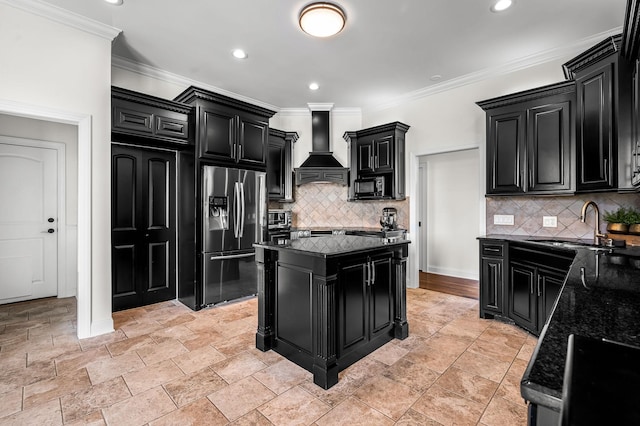 kitchen with stainless steel fridge, dark stone countertops, custom range hood, and a kitchen island