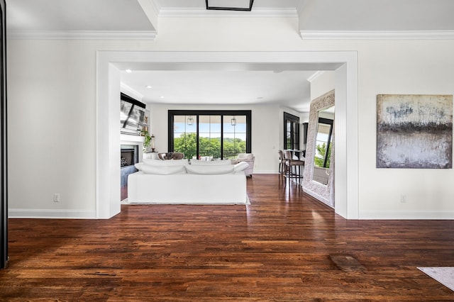 unfurnished living room with dark hardwood / wood-style flooring and crown molding