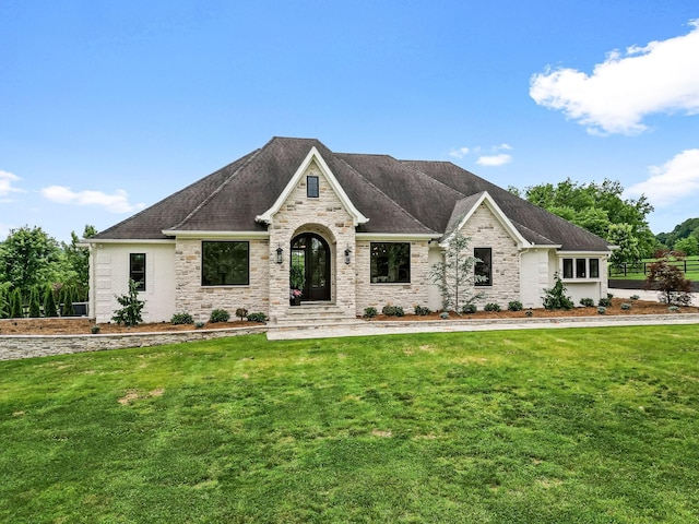 french country style house with a front lawn