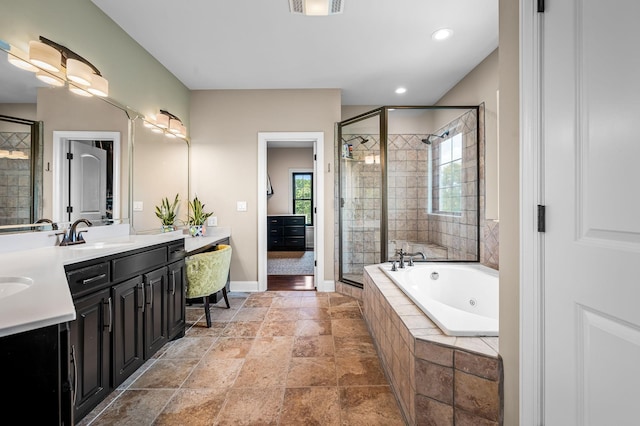 bathroom featuring vanity, separate shower and tub, and a wealth of natural light