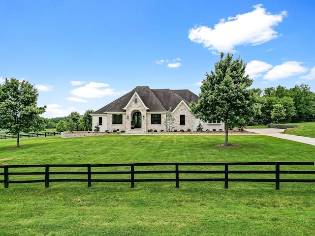 view of front of home featuring a rural view and a front lawn