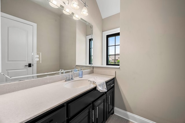 bathroom with vanity and vaulted ceiling