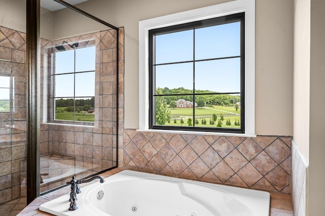 bathroom featuring a relaxing tiled tub