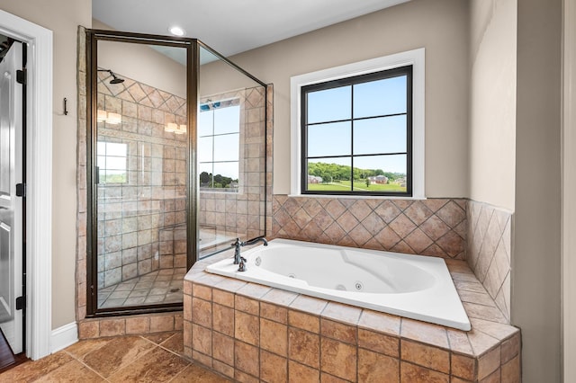 bathroom with tile patterned flooring and shower with separate bathtub