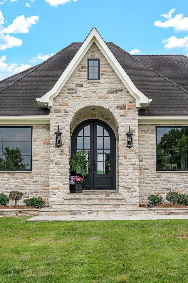 doorway to property with french doors and a yard