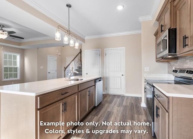 kitchen with dark hardwood / wood-style floors, sink, stainless steel appliances, crown molding, and a center island with sink