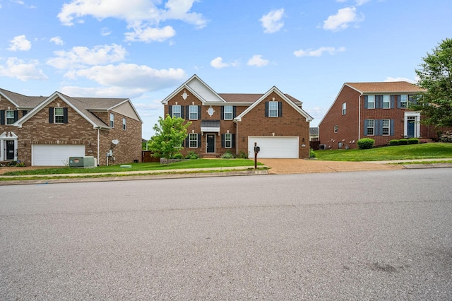 view of front of property with a front yard, a garage, and central AC unit