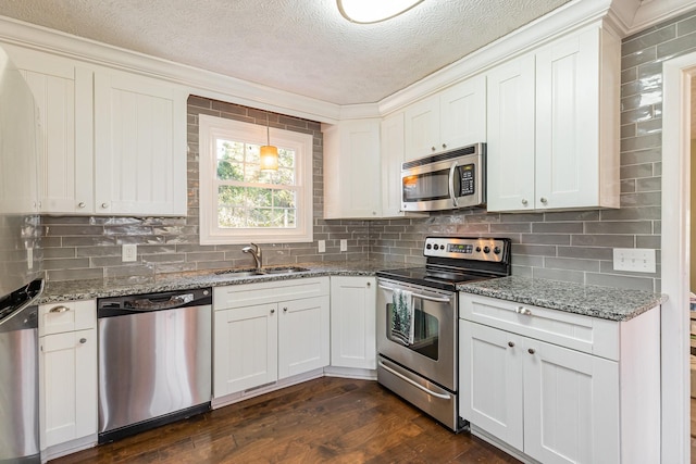 kitchen with sink, dark hardwood / wood-style flooring, a textured ceiling, white cabinets, and appliances with stainless steel finishes