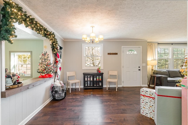 foyer entrance featuring a wealth of natural light, crown molding, and dark wood-type flooring