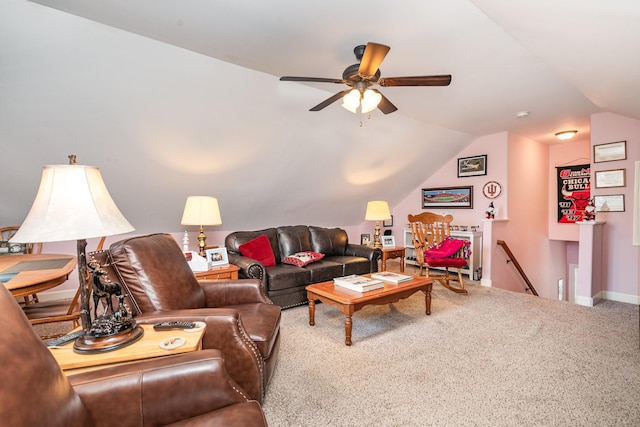 carpeted living room with ceiling fan and vaulted ceiling