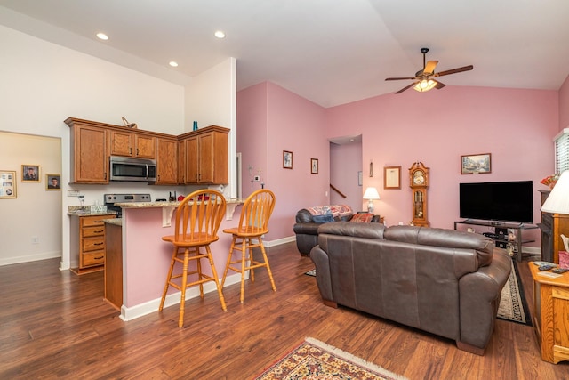 living room featuring ceiling fan, dark hardwood / wood-style flooring, and vaulted ceiling