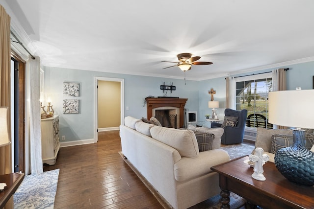 living room with ceiling fan, dark hardwood / wood-style flooring, and crown molding