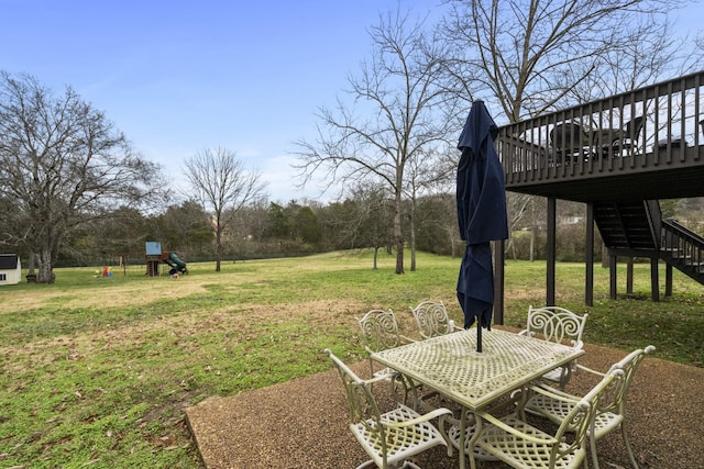 view of yard featuring a playground and a wooden deck