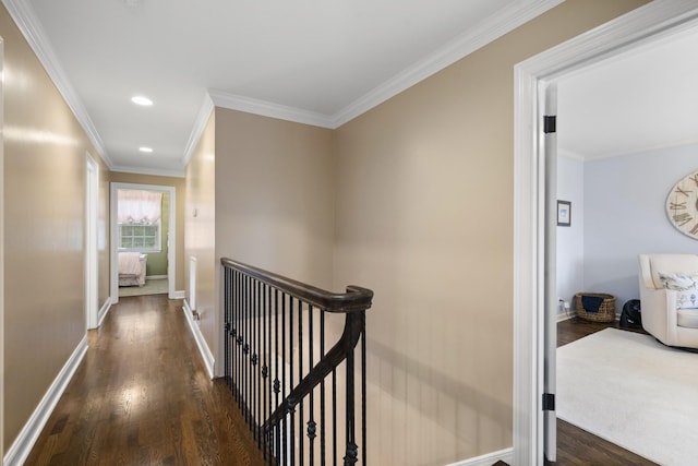 hall with dark wood-type flooring and ornamental molding