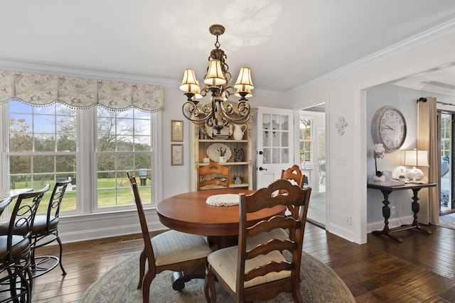 dining area featuring dark hardwood / wood-style flooring, ornamental molding, and a notable chandelier