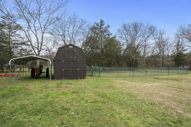 view of yard with a carport and a storage unit