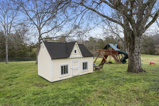 view of outbuilding with a playground and a lawn