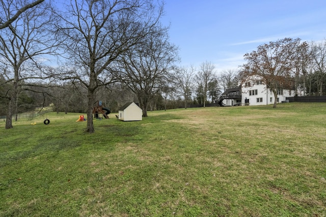 view of yard featuring a playground and a storage unit