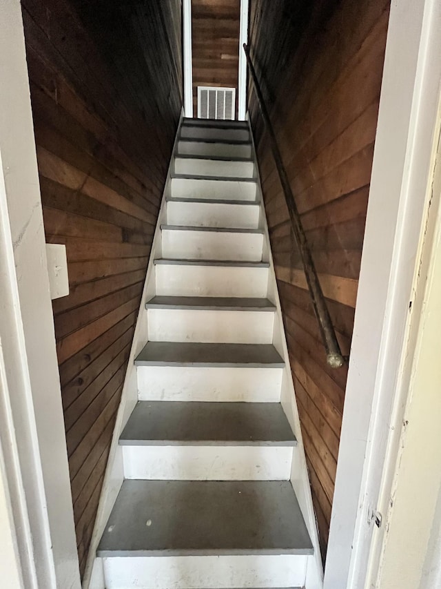 stairs with visible vents and wooden walls