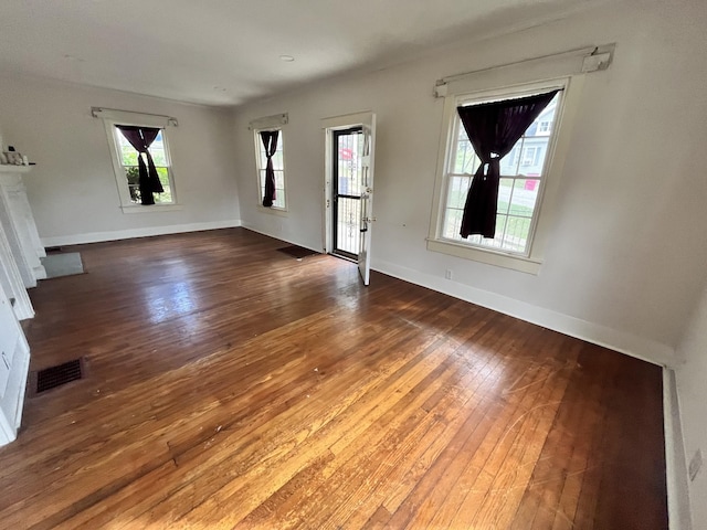 empty room with dark wood-type flooring