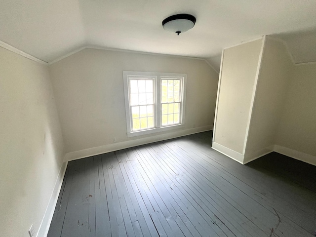 bonus room with lofted ceiling, dark wood-style flooring, and baseboards