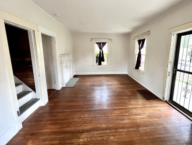 spare room with dark wood-style floors, baseboards, stairs, and visible vents