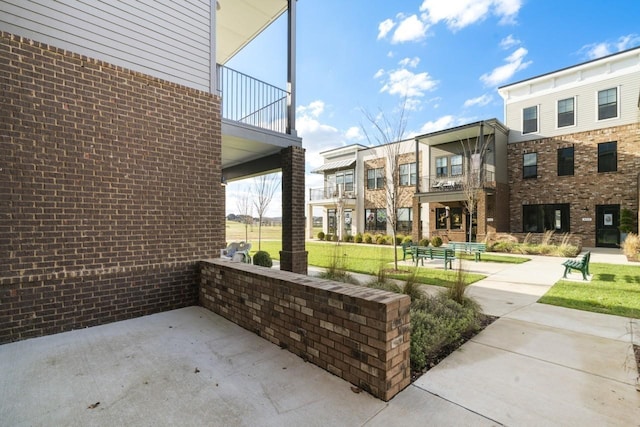 view of patio featuring a balcony