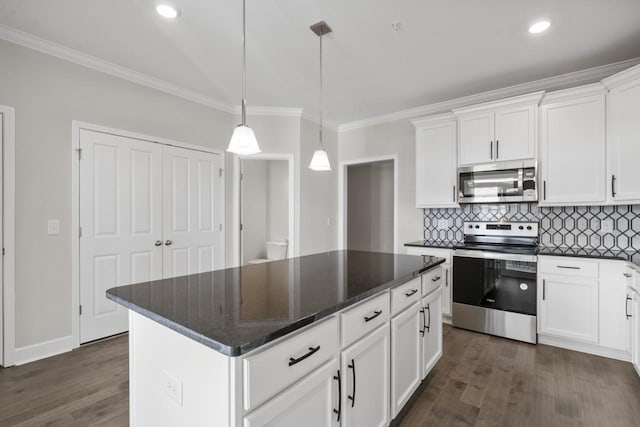 kitchen featuring a center island, dark wood-type flooring, stainless steel appliances, decorative light fixtures, and white cabinets