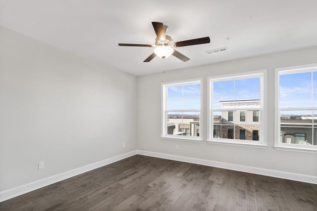 unfurnished room featuring ceiling fan and dark wood-type flooring