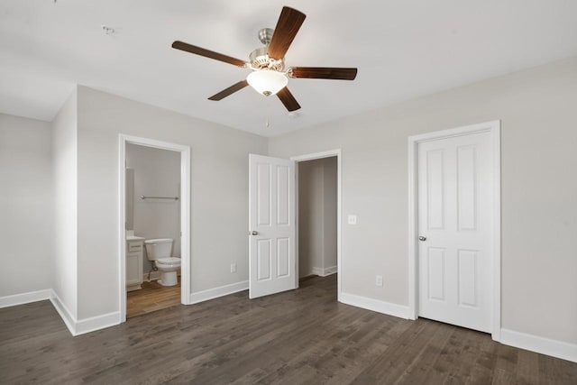 unfurnished bedroom featuring ceiling fan, dark hardwood / wood-style flooring, and ensuite bath