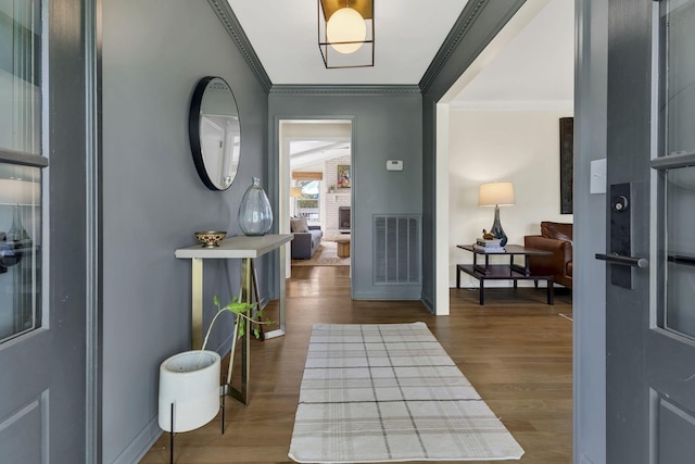 foyer with hardwood / wood-style floors and ornamental molding