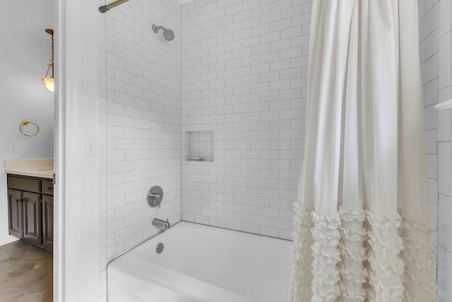 bathroom featuring tile patterned flooring, vanity, and shower / bathtub combination with curtain