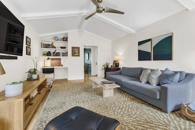 living room with ceiling fan, built in features, lofted ceiling with beams, and light hardwood / wood-style flooring