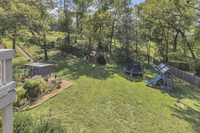 view of yard with a playground and a trampoline