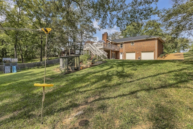 view of yard with a garage and a wooden deck