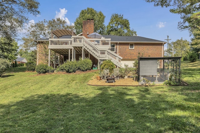 rear view of property with a lawn and a deck