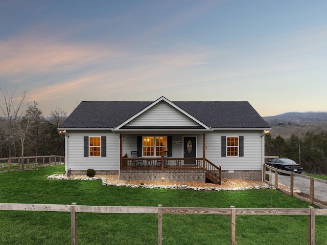 single story home with a lawn and a porch