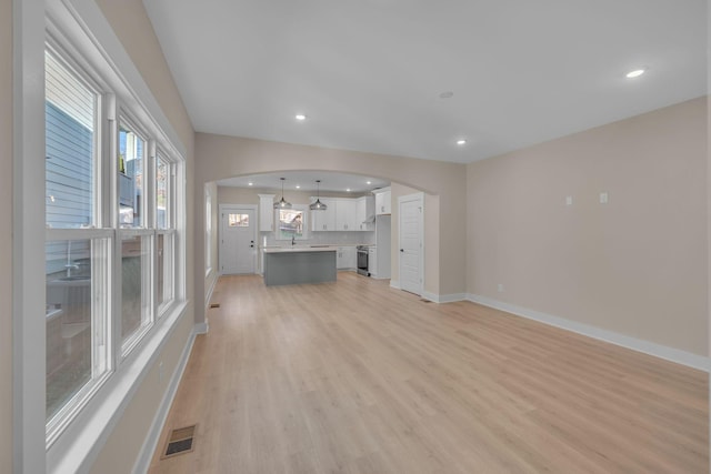 unfurnished living room with light wood-type flooring