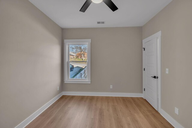 empty room with light wood-type flooring and ceiling fan