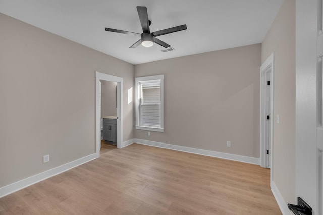 unfurnished bedroom featuring ceiling fan, light wood-type flooring, and ensuite bath