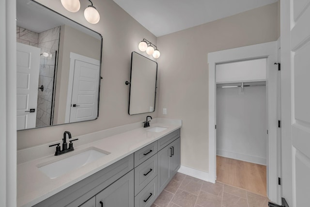 bathroom with tile patterned flooring, vanity, and a shower with shower door