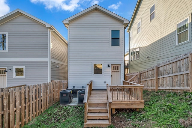 back of property with a wooden deck and central AC unit